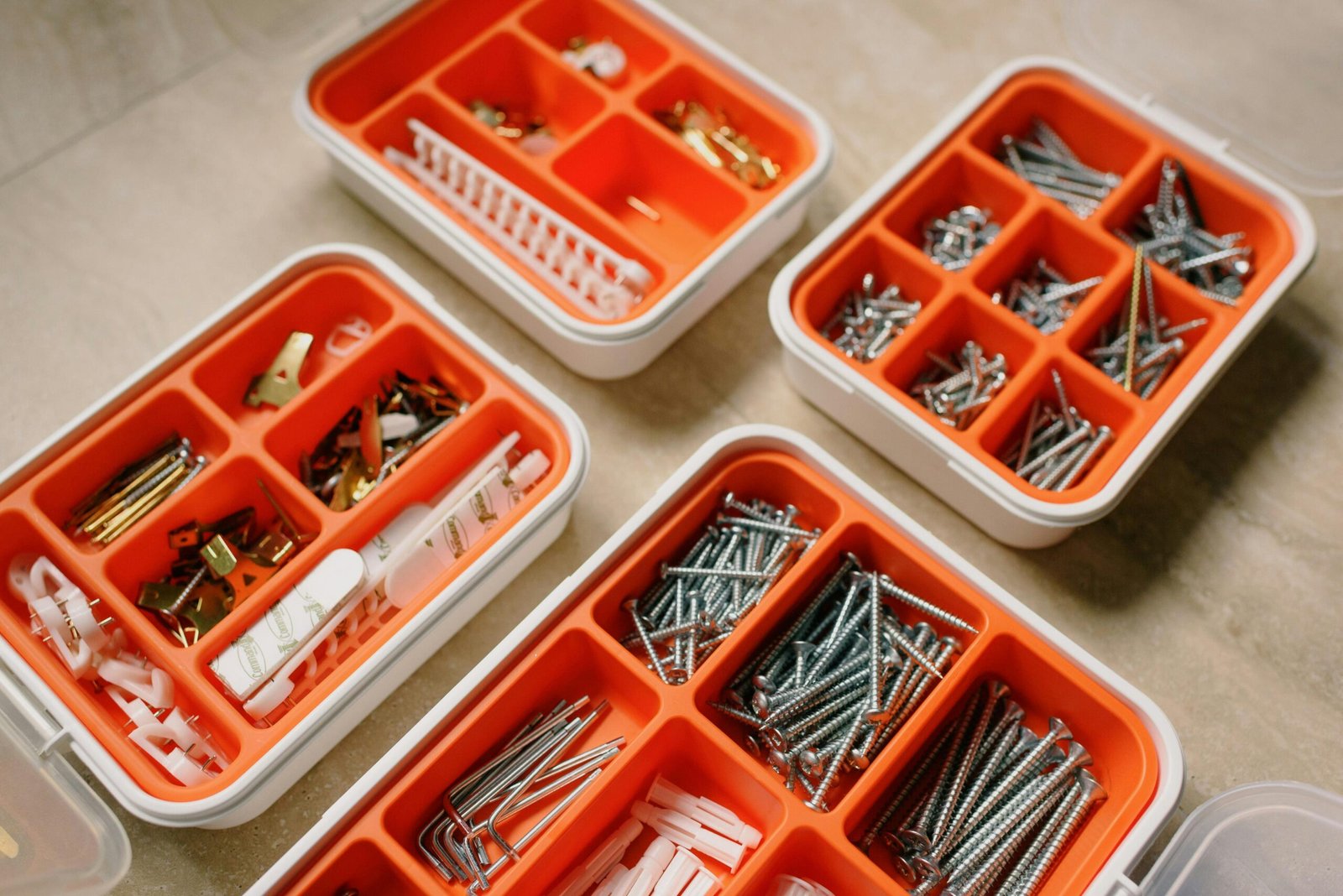 From above of boxes with different metal nails and plastic dowels in workshop, including retaining rings